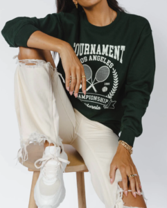 woman sitting on a stool wearing a green pullover 