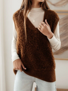 woman in a brown sweater vest