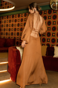woman in a copper maxi dress