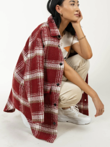 woman kneeling down with a red plaid jacket