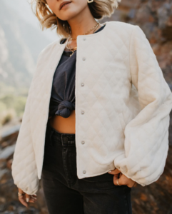 woman in a white bomber jacket